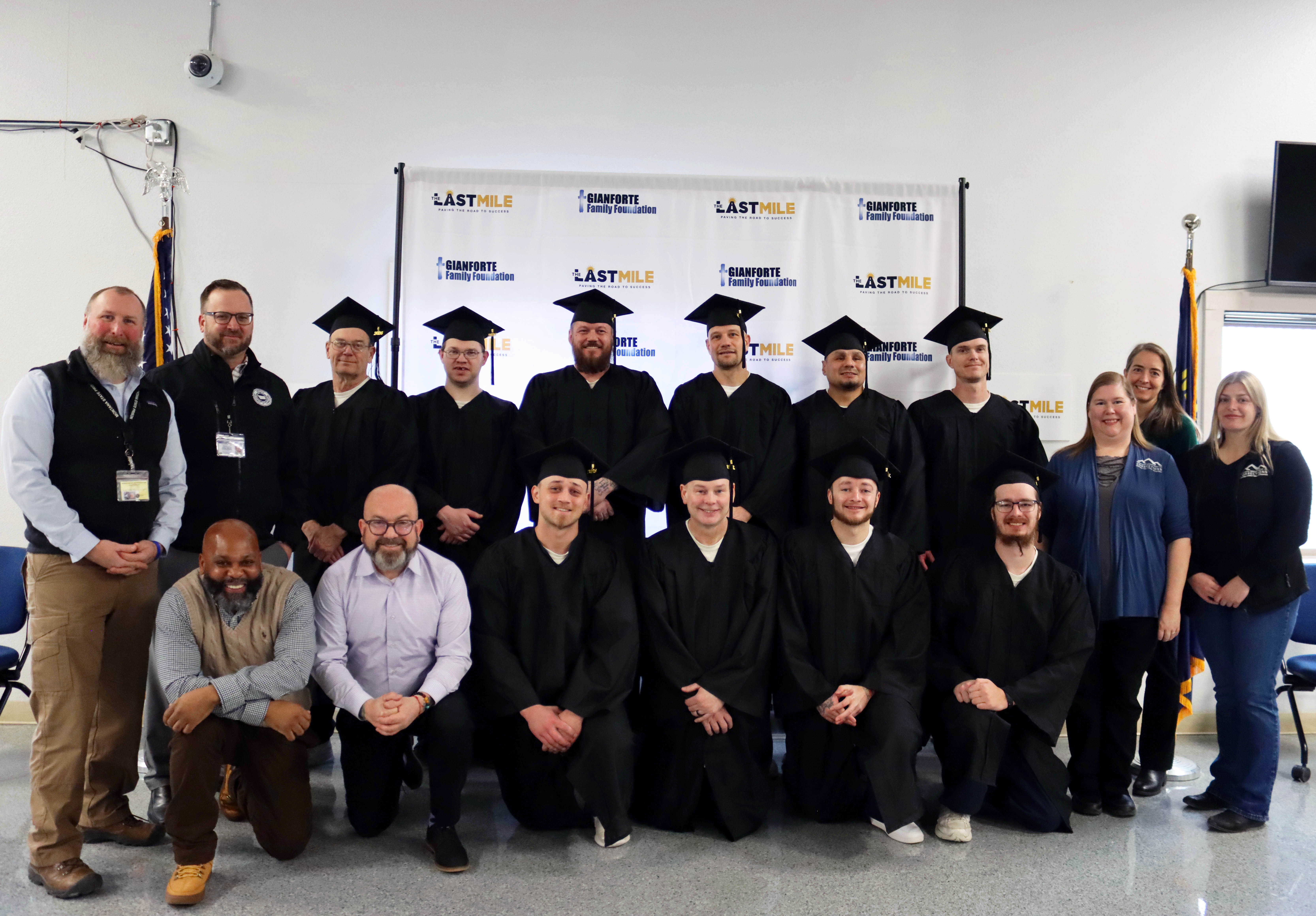 A group of The Last Mile graduates wearing their caps and gowns. 