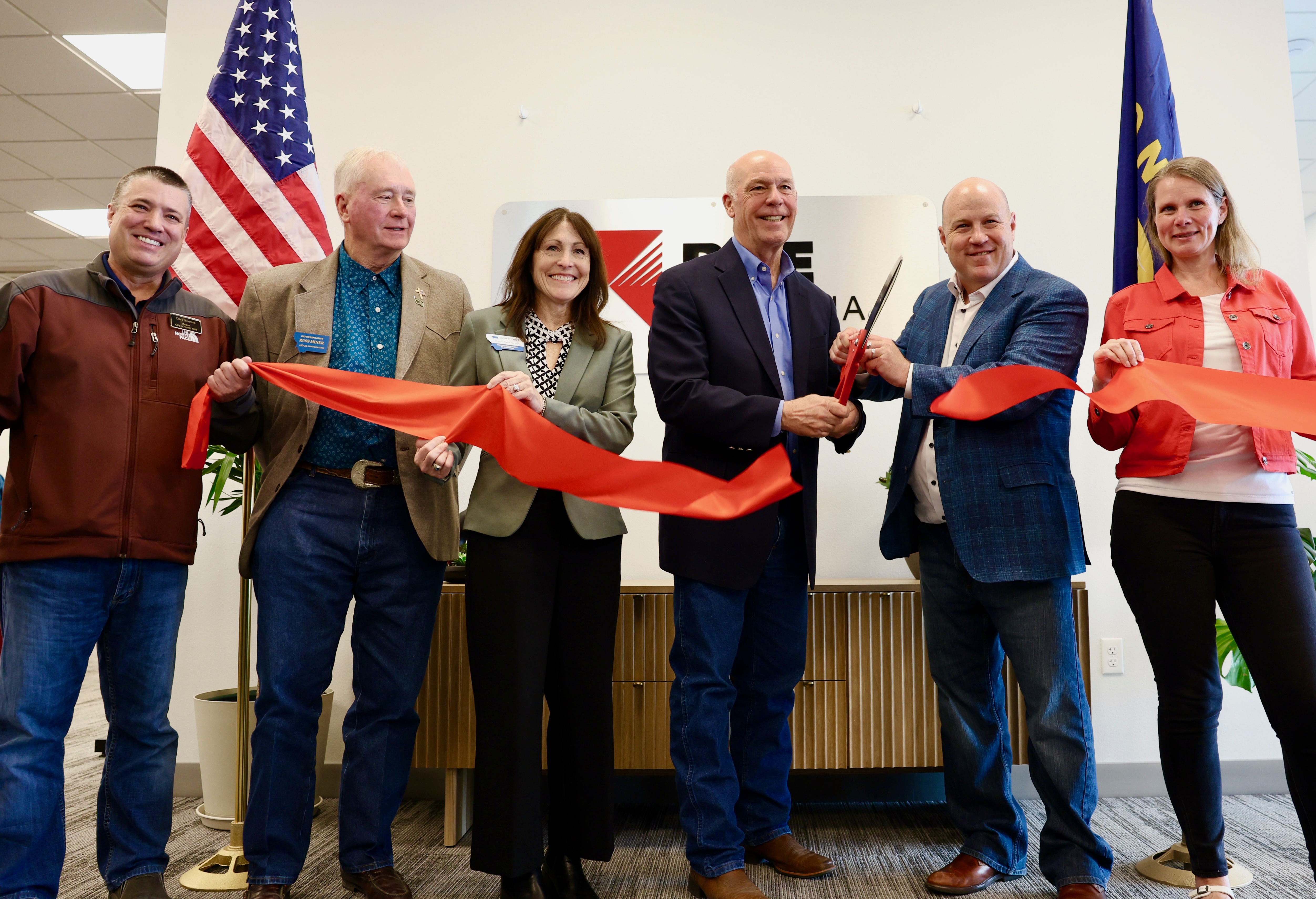 Gov. Gianforte cutting the ribbon cutting at the opening of the BHE Montana Great Falls Office 