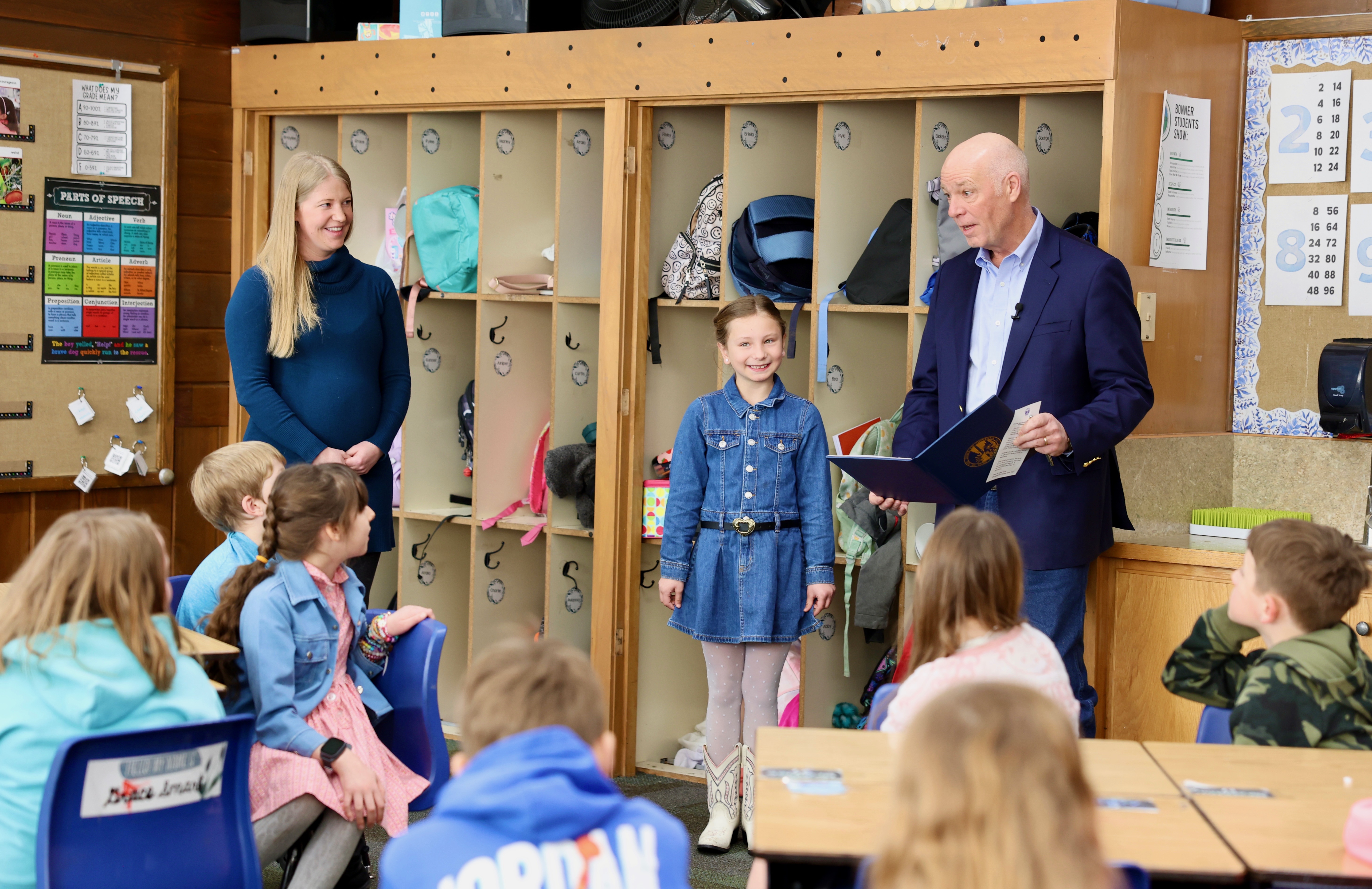 Gov. Gianforte (right) proclaiming March 3 as Third Graders Day with third grade student Blakely Wagner (middle) at Bonner School