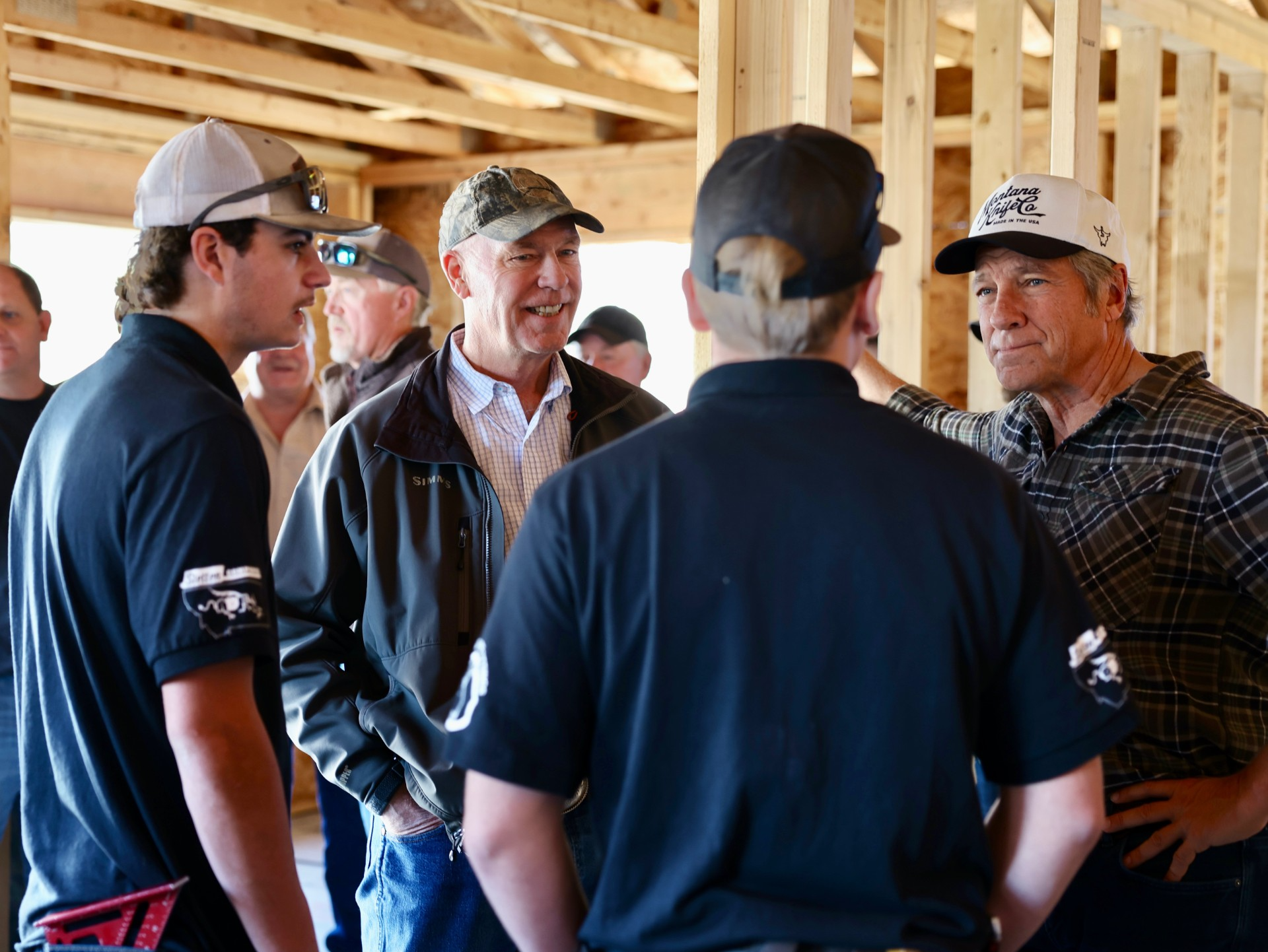Gov. Gianforte (middle left) and Mike Rowe (right) talking with Great Falls students participating in the High School House Program