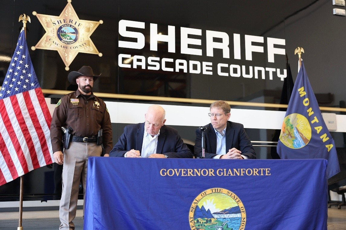 Gov. Gianforte signing House Bill 323 with Sheriff Slaughter and Rep. Steve Fitzpatrick in Great Falls