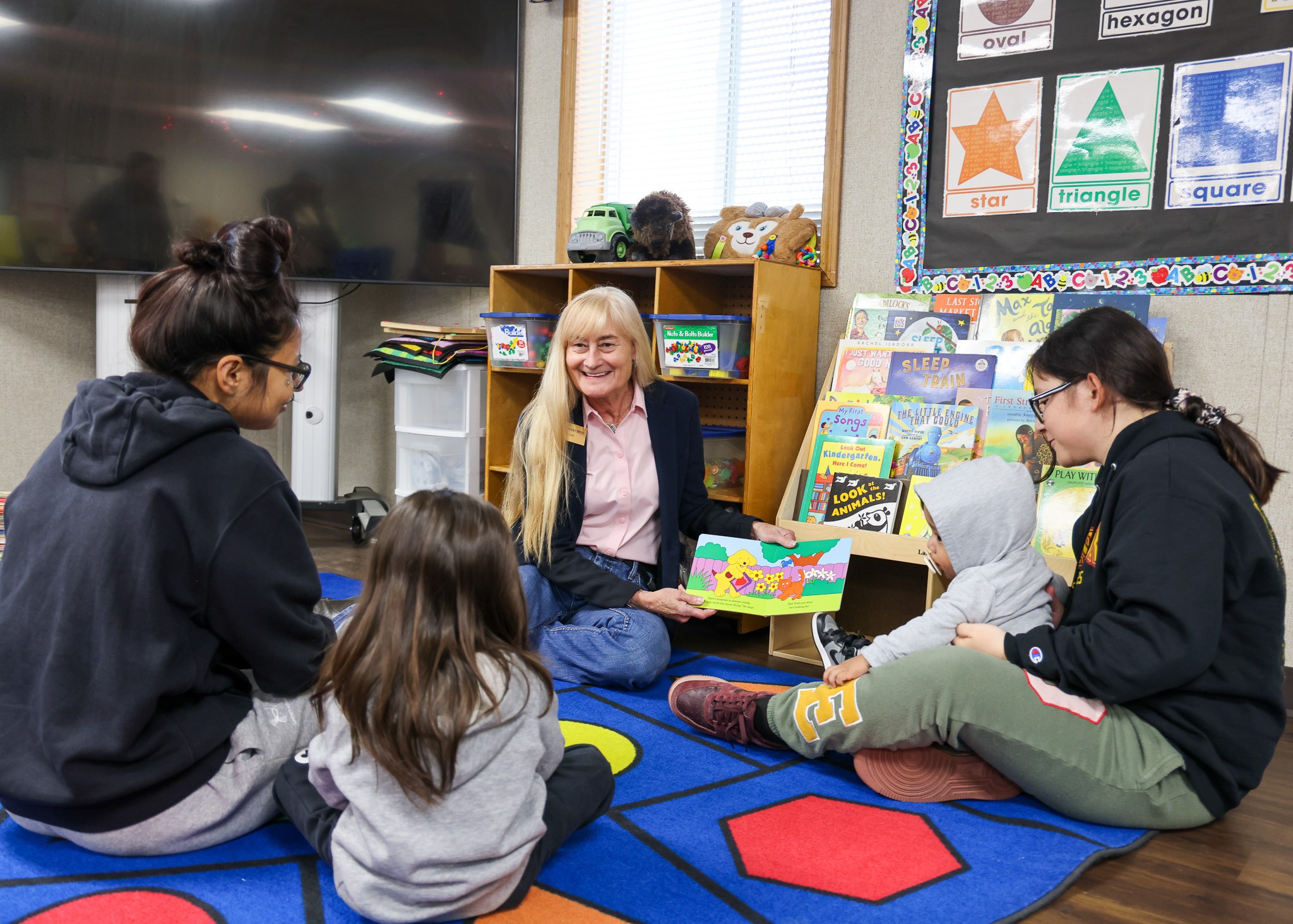 First Lady Susan Gianforte reading to children at Fort Peck Head Start in Poplar
