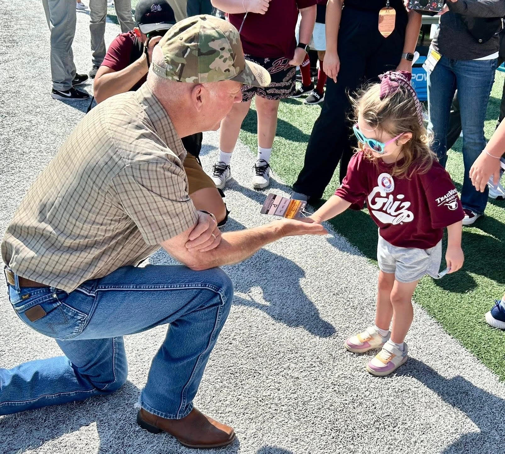 Gov. Gianforte visiting with Hope Child, Izzy, at a University of Montana football game in Missoula in September