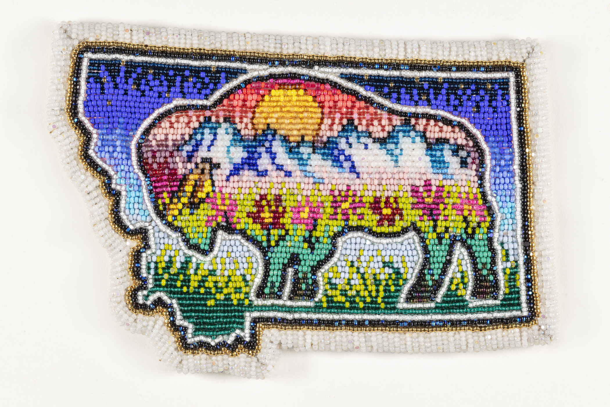 Beaded artwork depicting a bison inside the outline of the state of Montana.